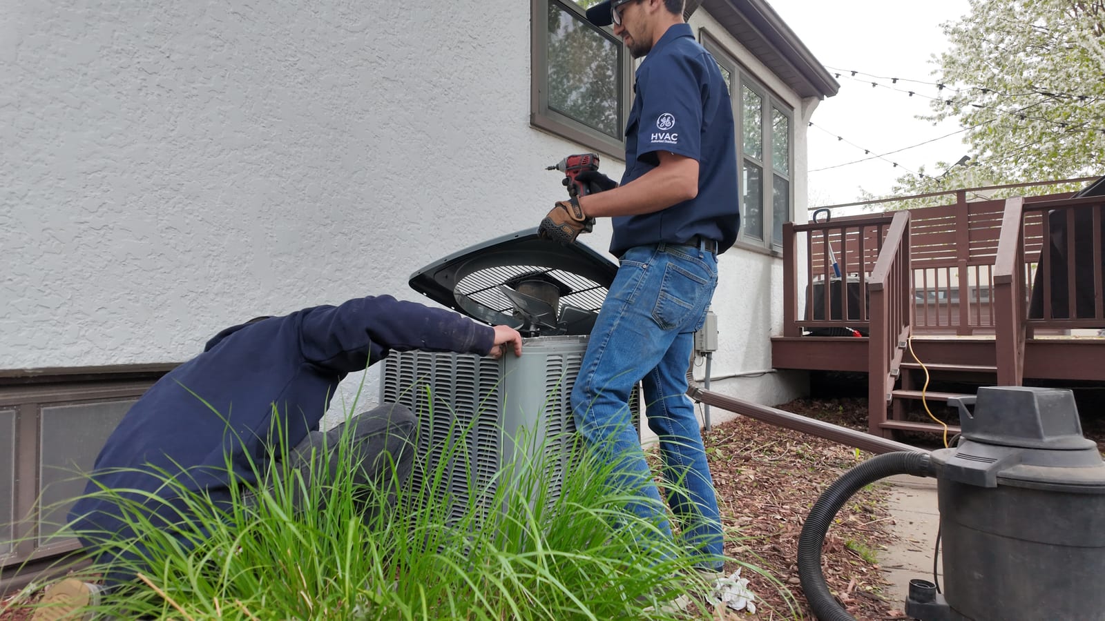 Justin Fodor of Northern Standard Heating & Air working a tune-up on a Twin Cities job site
